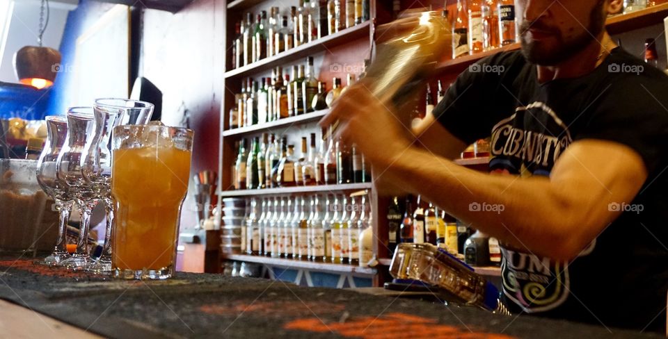 A bartender making my cocktail drink for me and five friends. He was a good sport and didn't mind my camera on him ... thank you for my delicious "Heaven" drink 🍹 