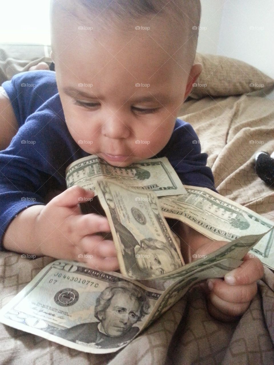 Baby Money. trying to pay bills while my son tries to cuff some of the bill money