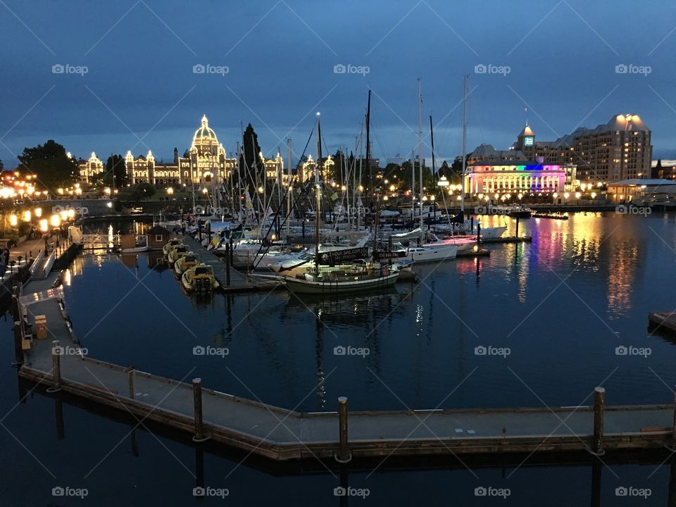 Sailboat at harbor near illuminated city