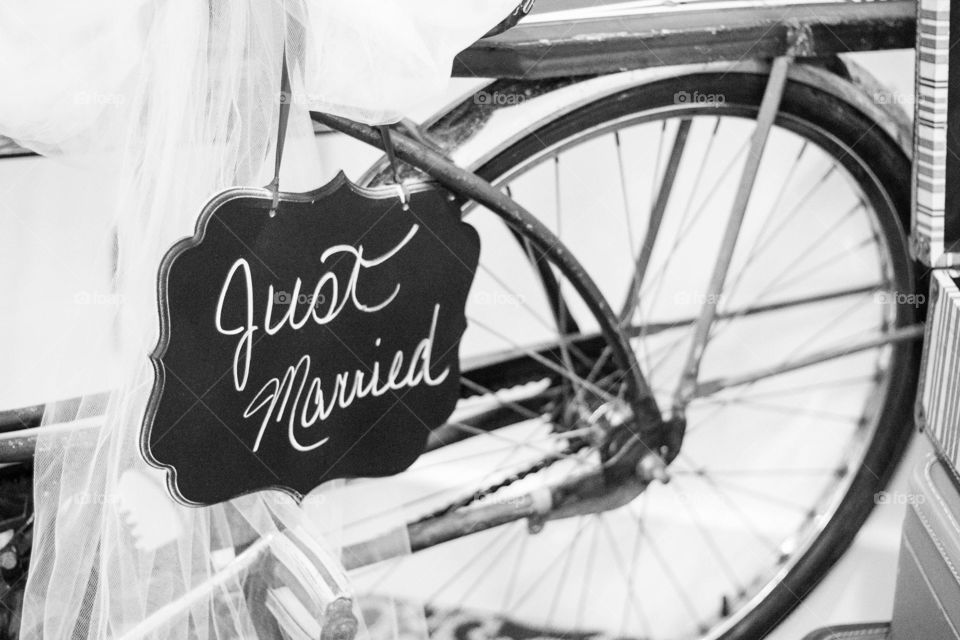 Black and white image of vintage bicycle with just married sign as wedding decoration