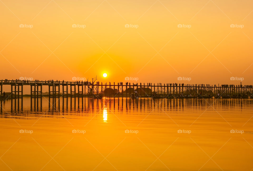U Bein Bridge at sunset with silhouetted people