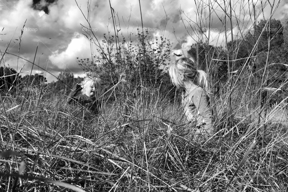 Side view of girl standing in dry field