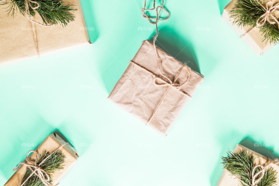 Christmas gift lying on green background. Flatlay items. Flat lay, top view, surprise, happy new year, merry, tree, packing, packed, wrapping, celebrating, holidays, winter, nobody, background 