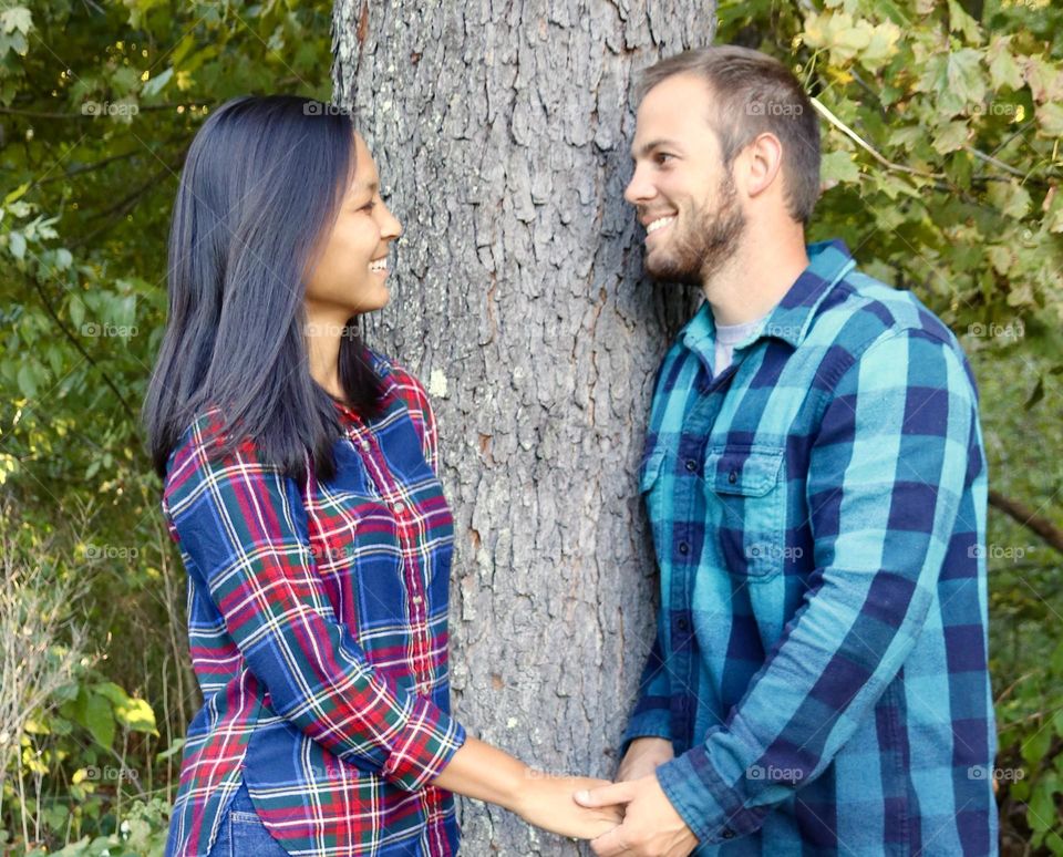 Young man with beard, young woman with long dark hair smiling at each other 