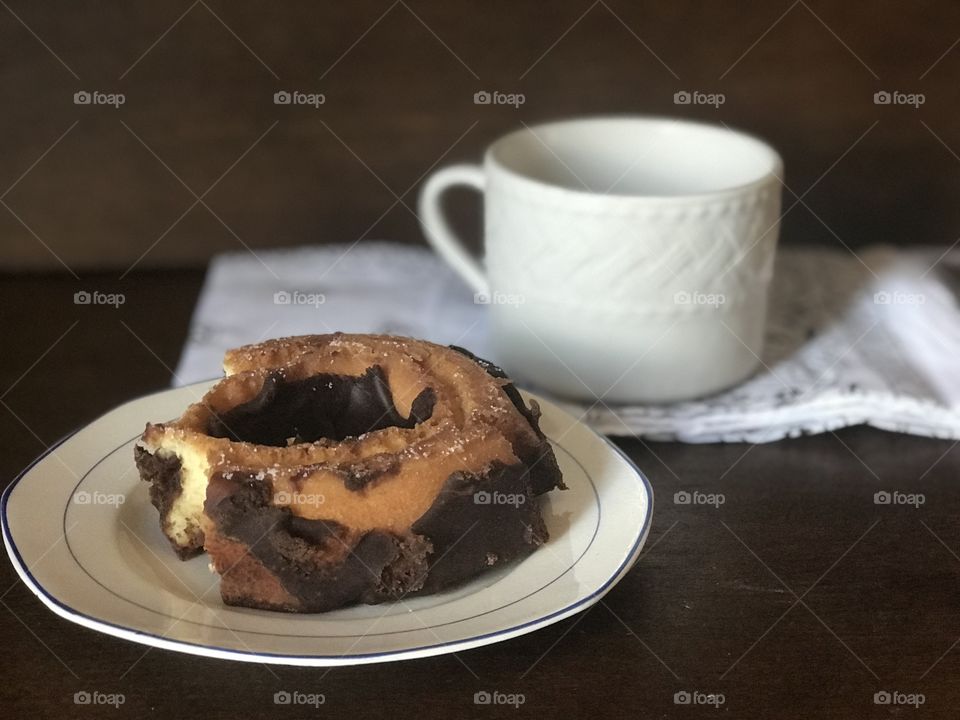 A yummy and delicious chocolate crumble donut with coffee is happiness in the morning for breakfast. 