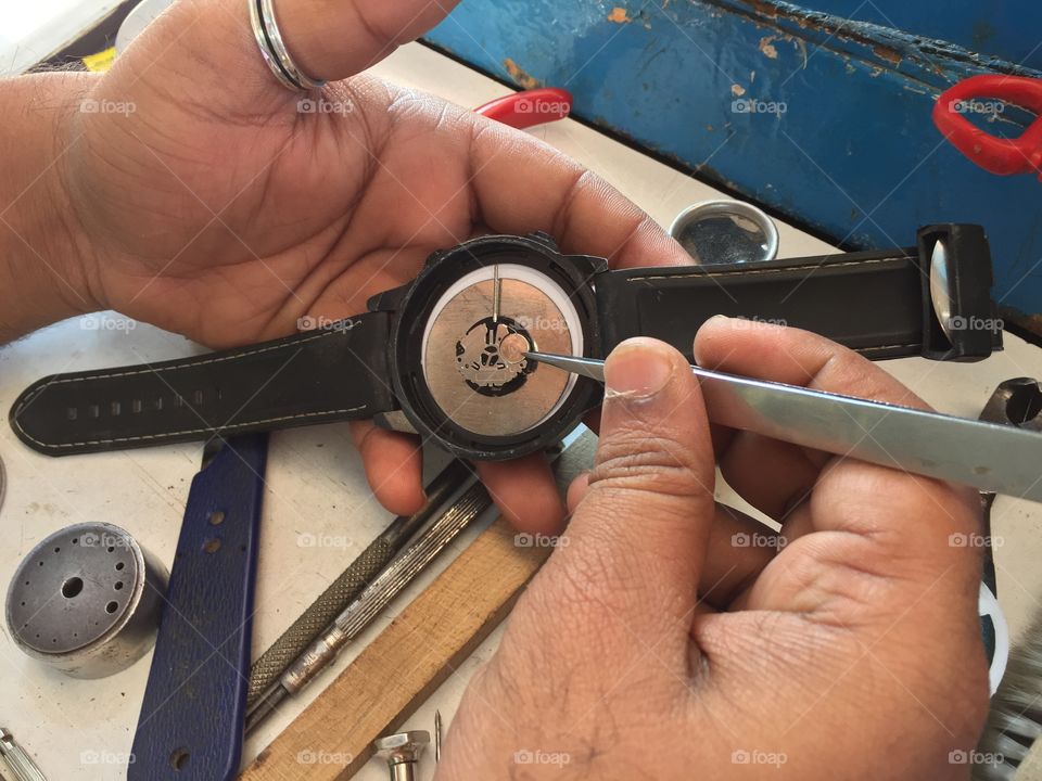 Close-up of man repairing watch