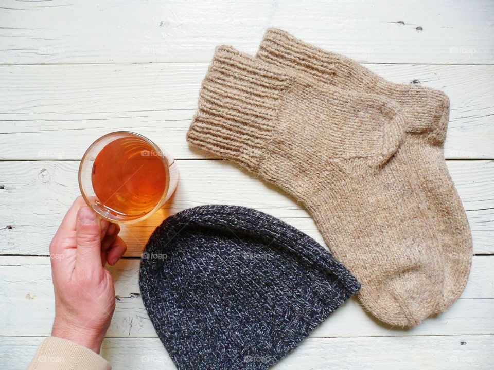 cup of hot tea, socks and a hat will warm in the cold