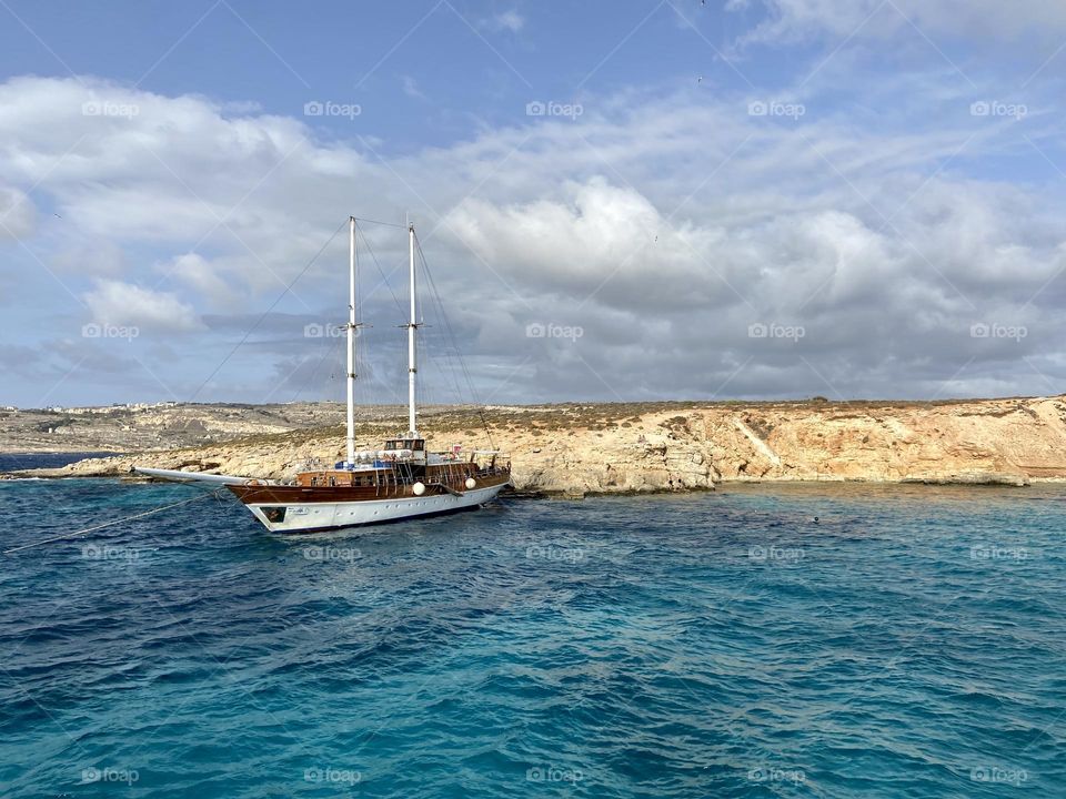 Sailing boat moored by the Cliff of the blue lagoon in Malta 