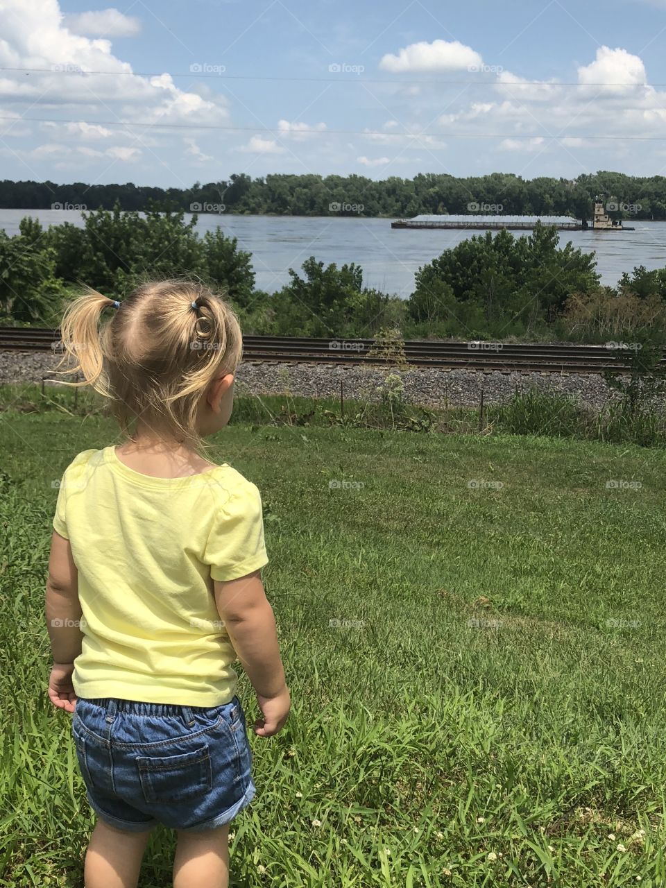 Child looking at passing barge