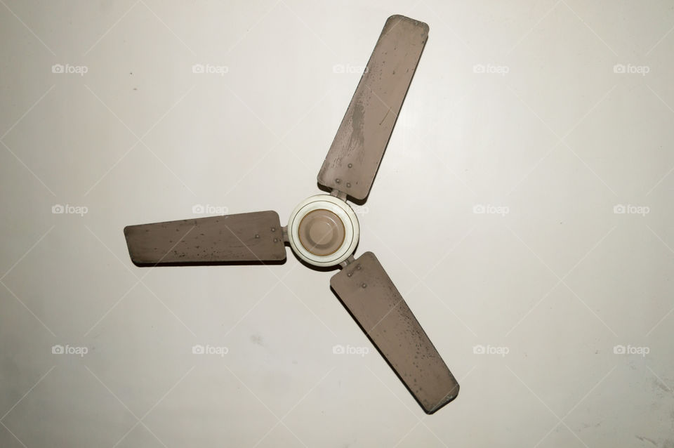 Antique and old electronic metal ceiling fan with three blades in vintage house Isolate on white background.