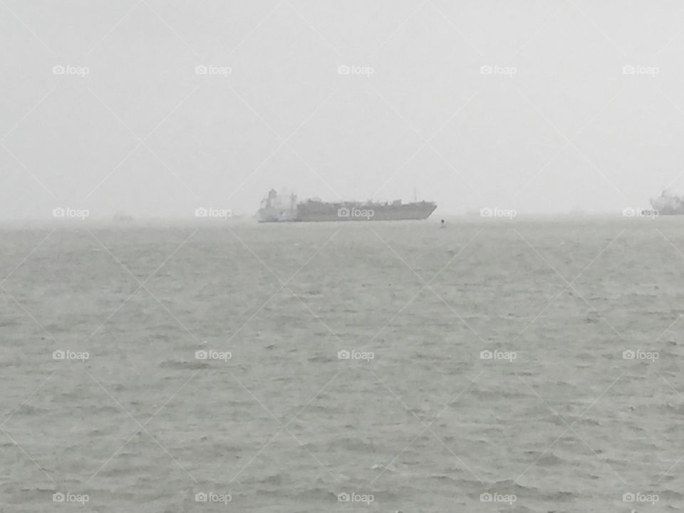Ship anchored off Galveston during rough weather 
