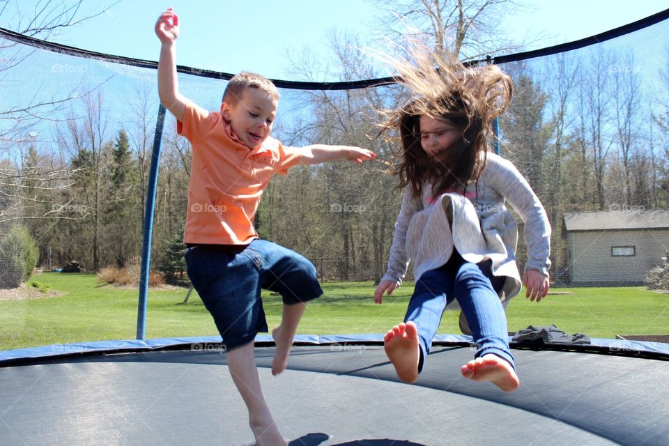 Siblings on the trampoline 