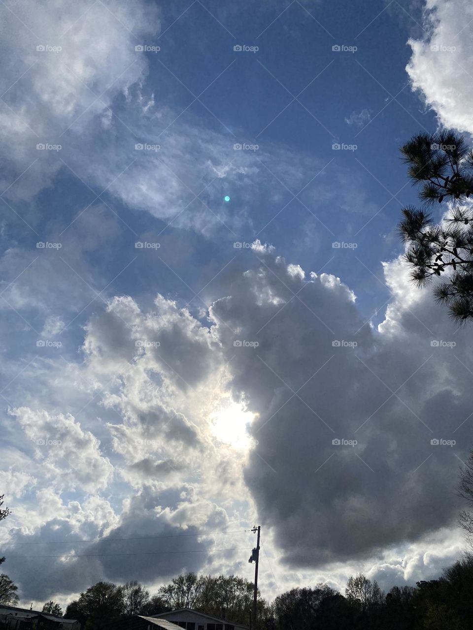 The Sun peaking from behind the clouds 