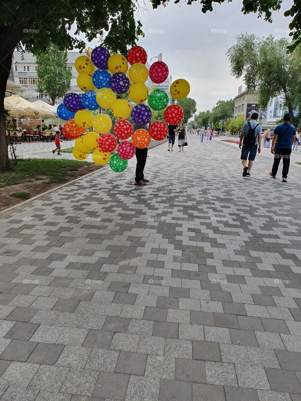 man selling baloons on the street
