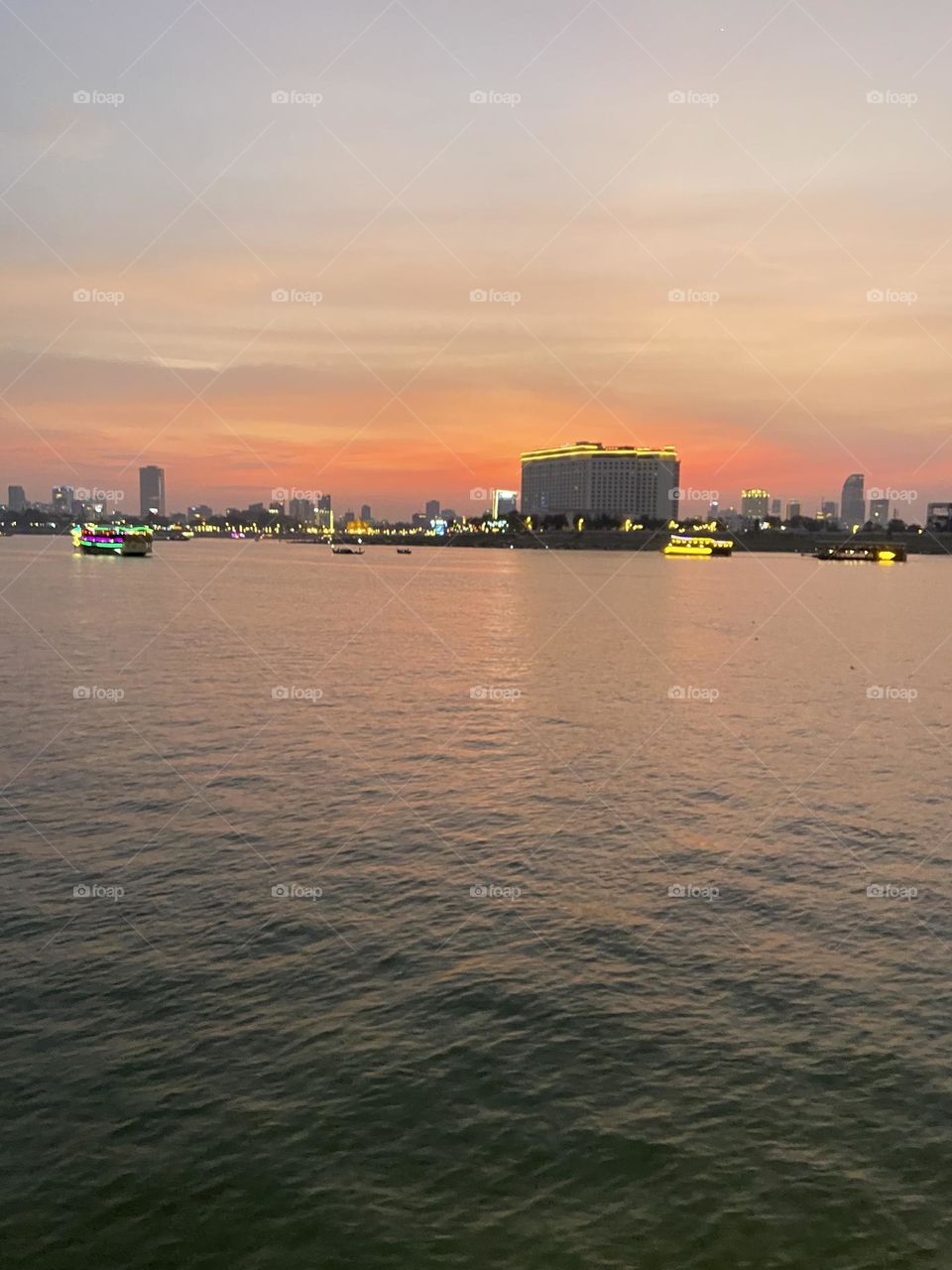 Beautiful sunset in front of city and water 