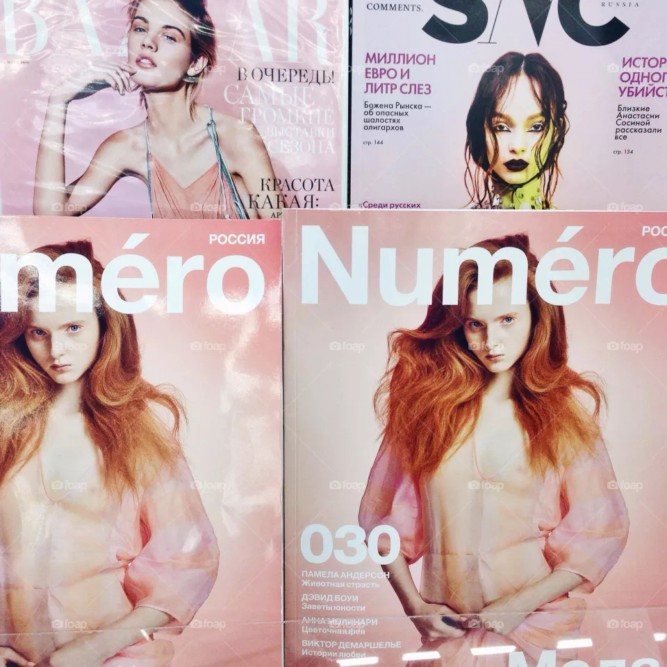 Pink magazines on a counter 