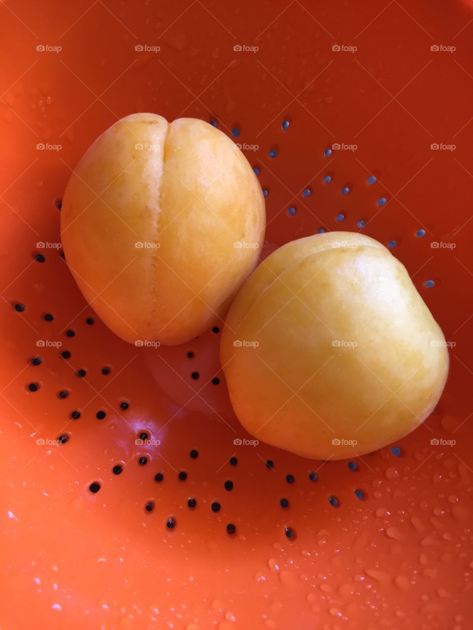 Apricots in orange colander 