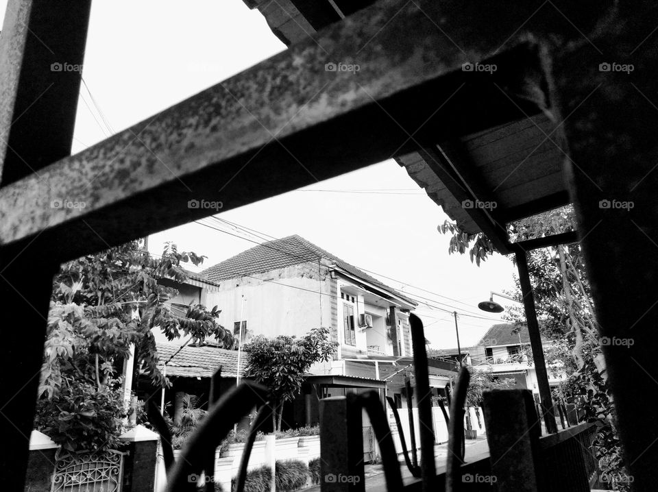 From behind the iron fence