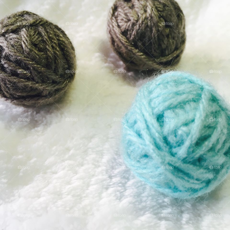 These are yarn balls . I thought they were beautiful macro shot models because they are colorful under a white background. 