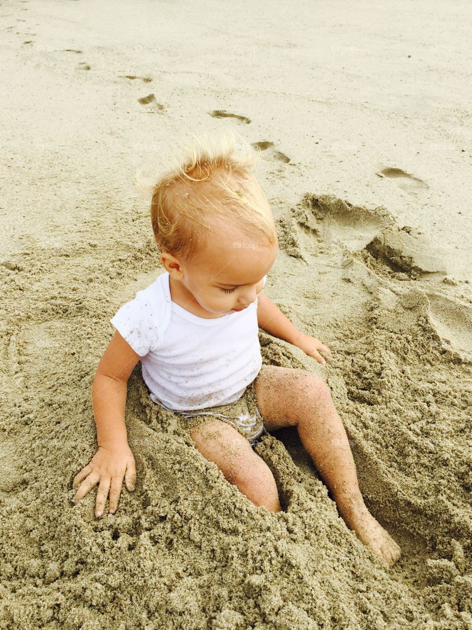 Little boy playing in sand
