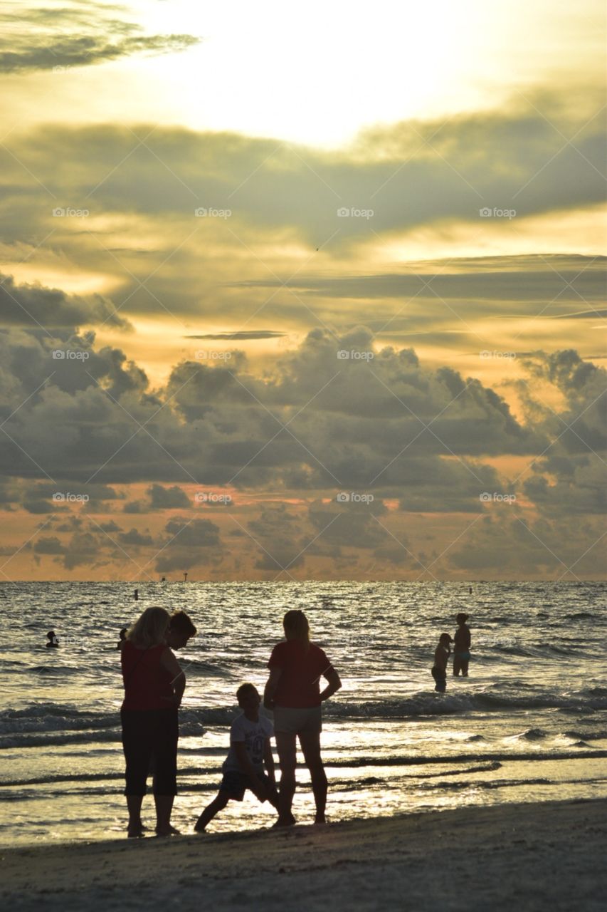 People on beach at sunset