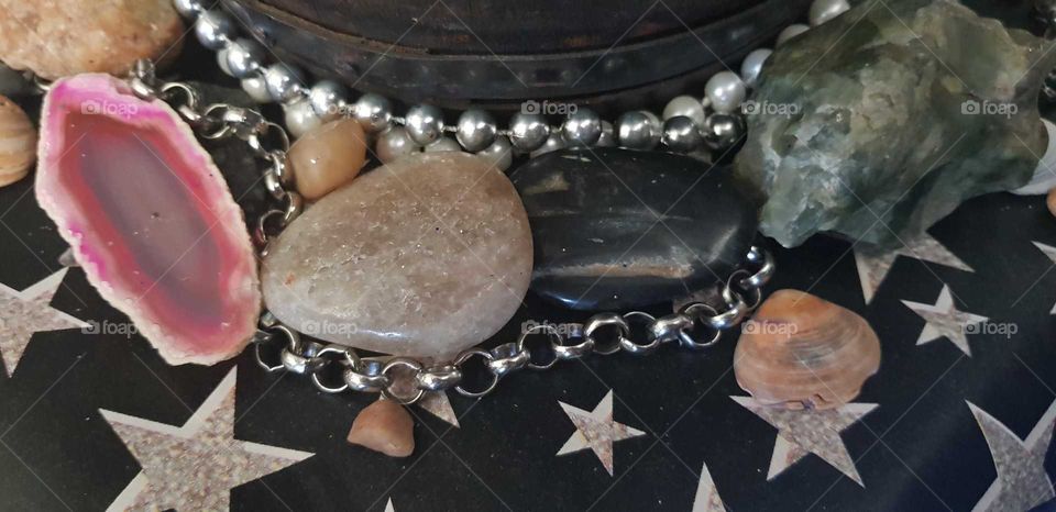 Crystal's and polished stones. Chains and beads. stars around an old barrel. Unique look created at home.