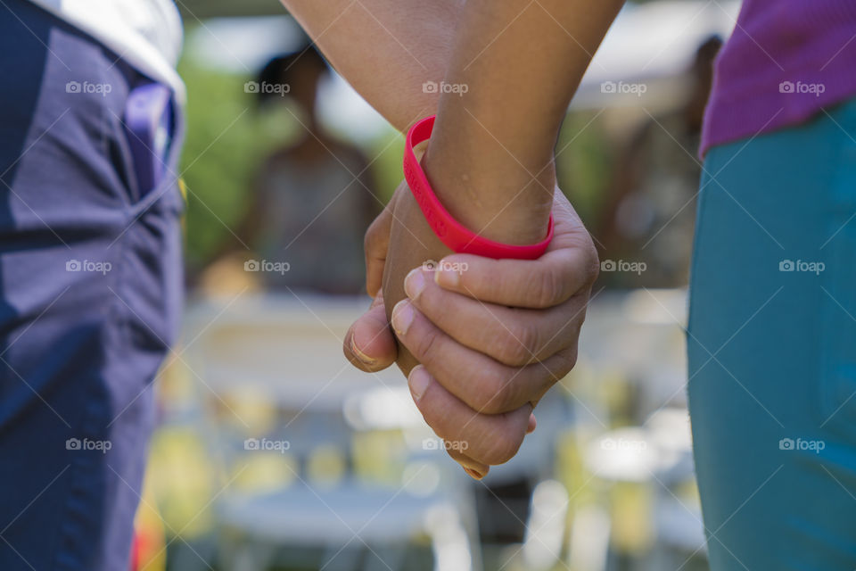 Close-up of two people holding hands