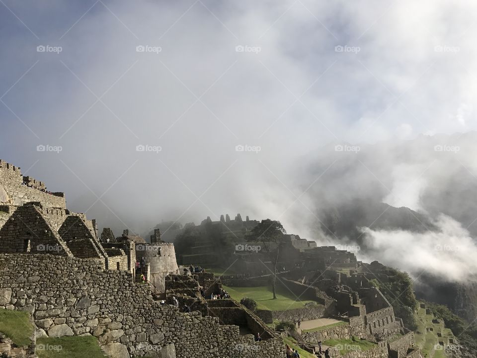 Fog begins to lift off of Machu Picchu, Peru. 