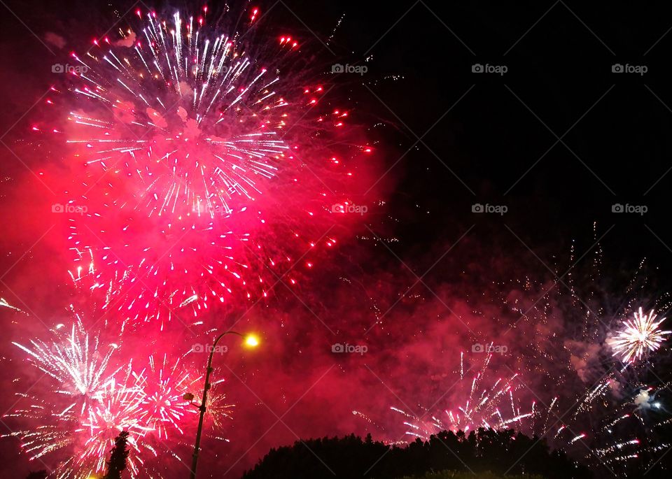 Red explosion of fireworks against night sky