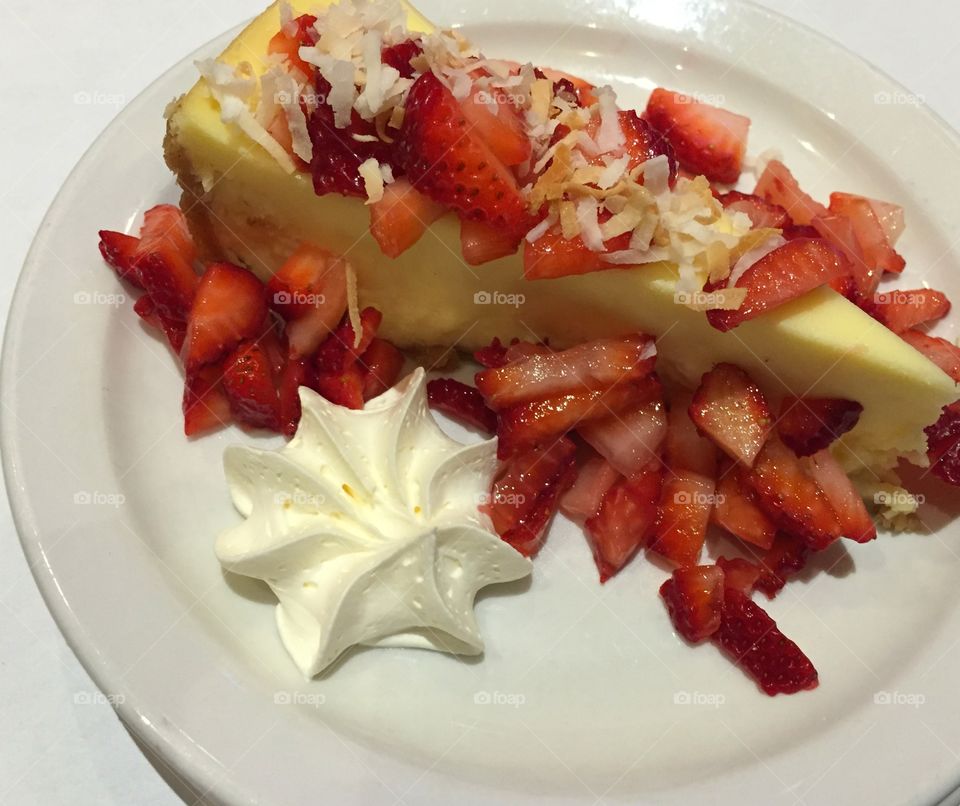 After a meal deal. This delightful tasting cheesecake topped with strawberries and shredded coconut with a cool whip star are to die for