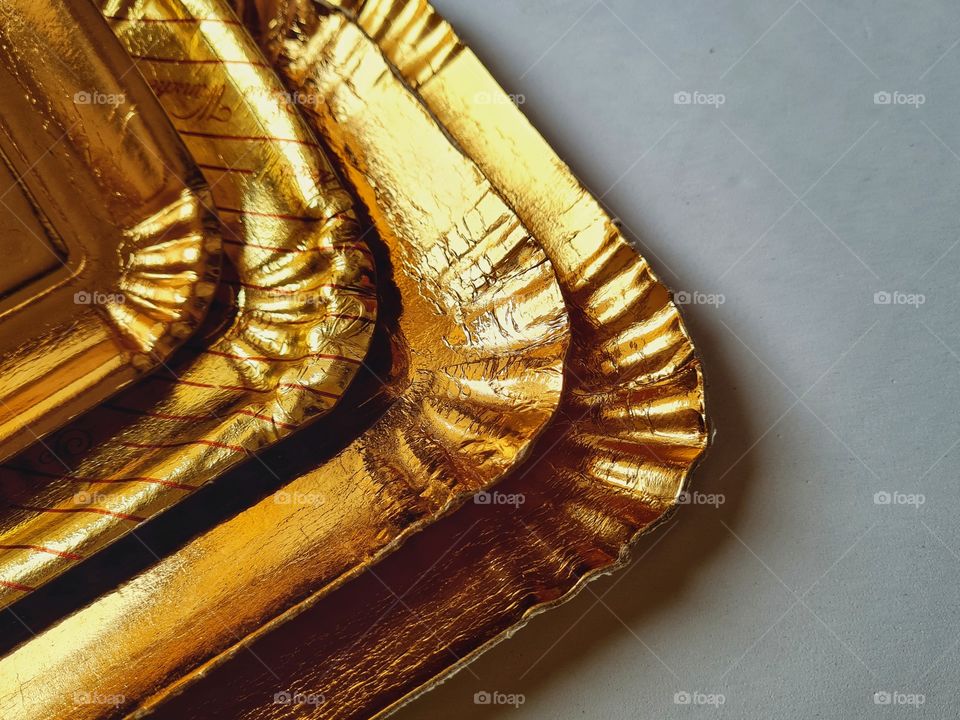 detail of golden paper trays