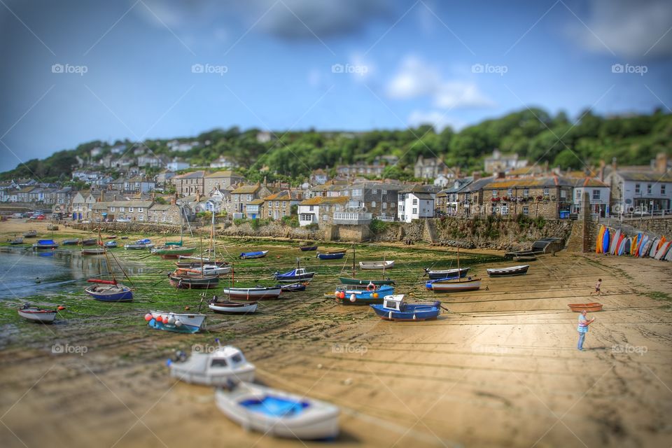 A traditional Cornish fishing village at low tide called Mousehole.