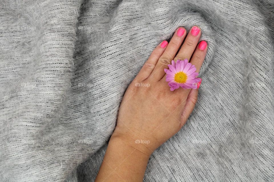my hand with pink nails and pretty flower
