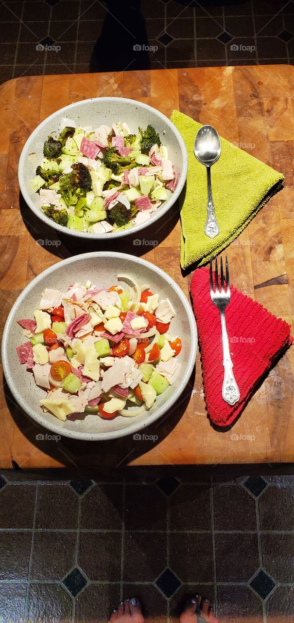 Salads, healthy food grown in local gardens. Both bowls have different ingredients. Traditional  food.