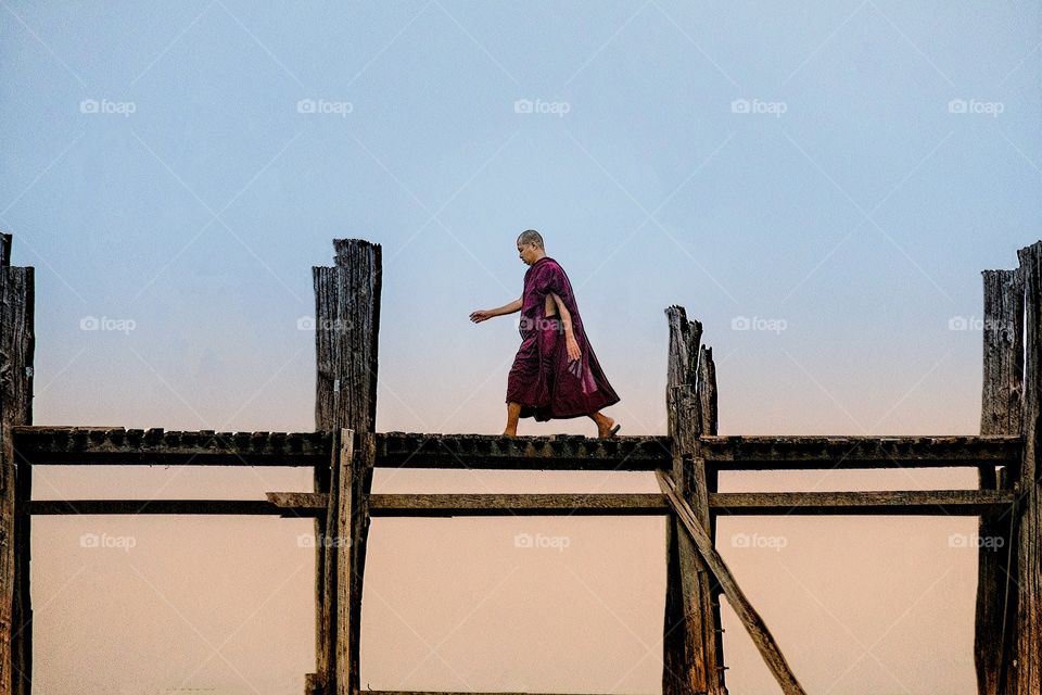 Local Myanmar monk on the bridge in early morning