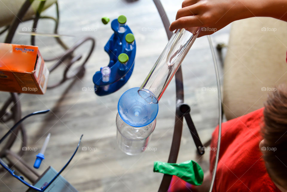 School aged child doing a science experiment at home