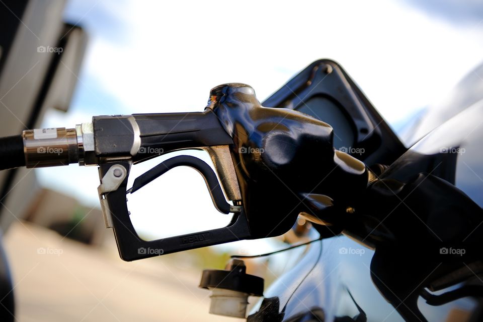 Gas pump inserted in car