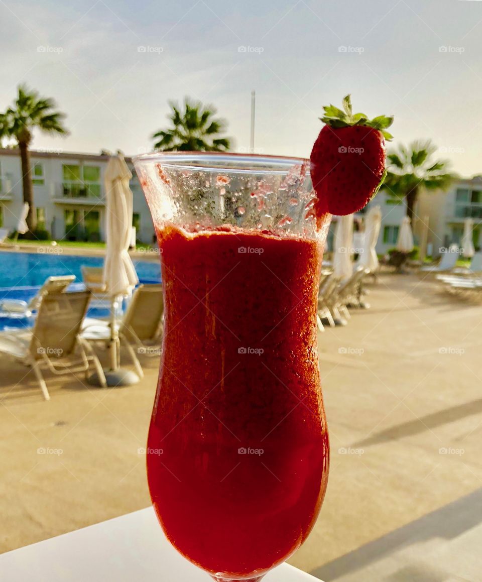 Strawberry smoothie by the pool 