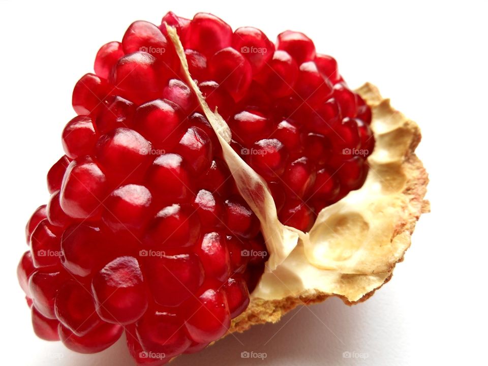 Pomegranate seeds on white background