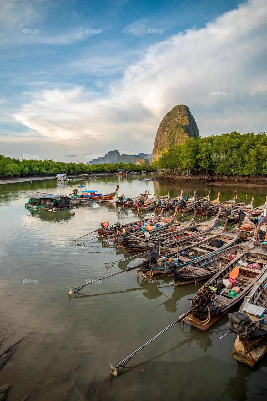 Rows of local fishing boats lined up in a beautiful sea view