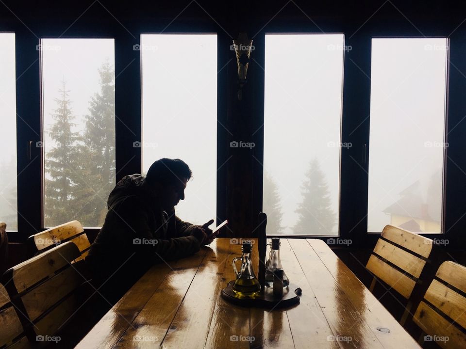 Silhouette of a man texting