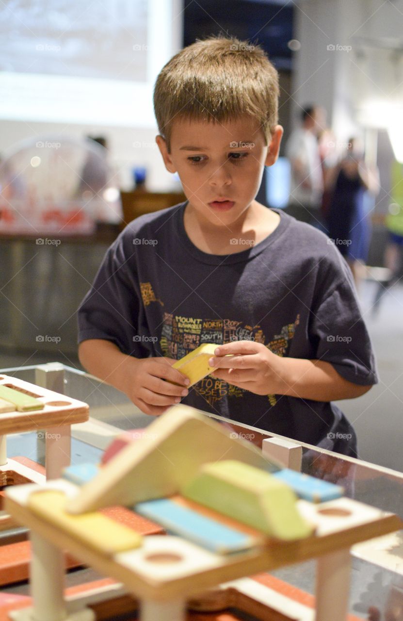 Boy making toy house