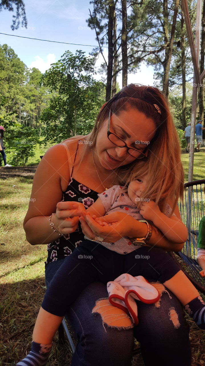 kid in the midel of mother's hair