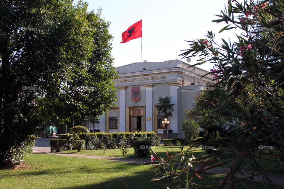 View of the Albanian parliament, with the national flag flying from the roof, in Tirana, Albania.