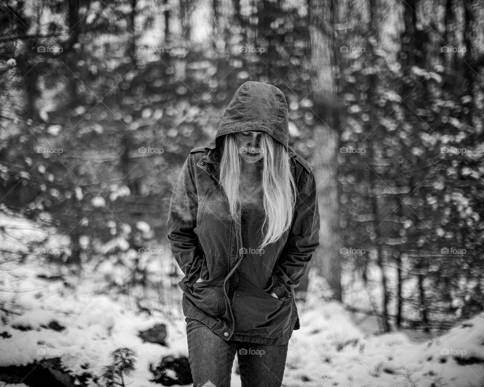 Woman walking through a forest on a cold day; Black and White