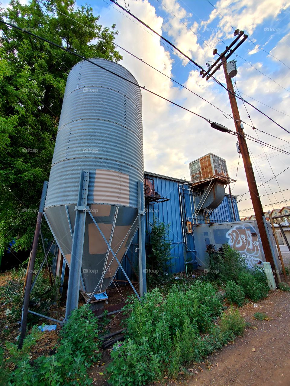 A large storage tank adds a cool industrial vibe to a downtown alley