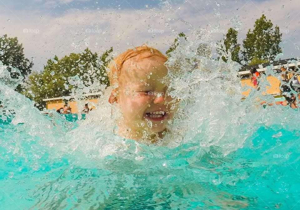 Little girl of two years old playing in the water at Lindängsbadet in Malmö Sweden.