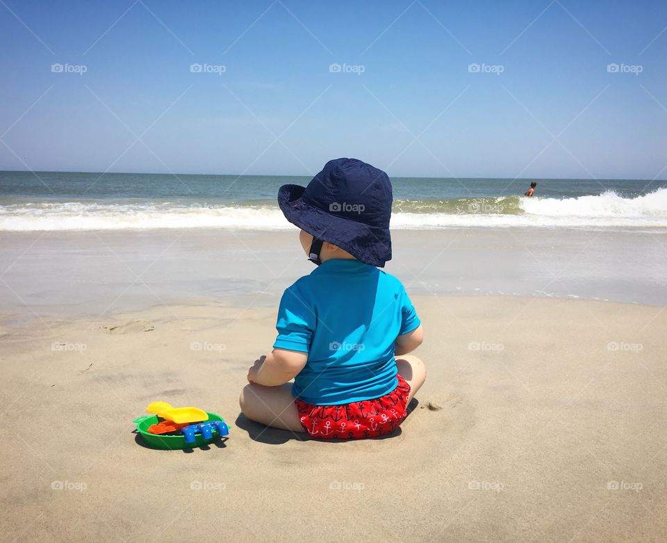 Baby sitting on the beach