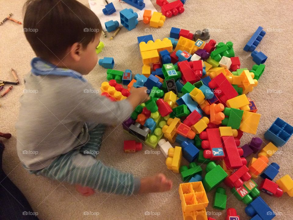 Child playing with color blocks