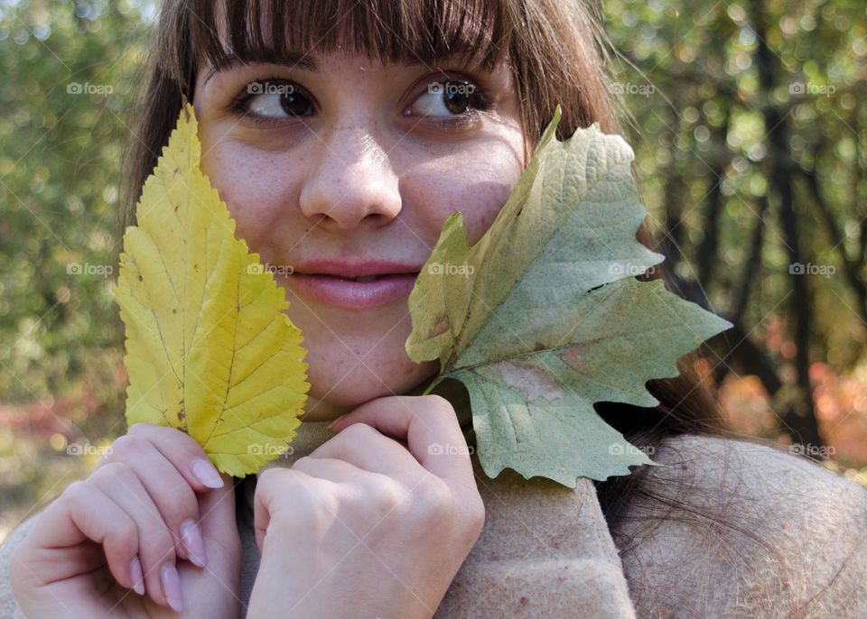 Smiling Young Girl on Autumn Background